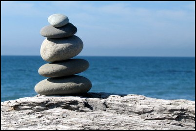 Zen rocks on the beach facing the ocean.